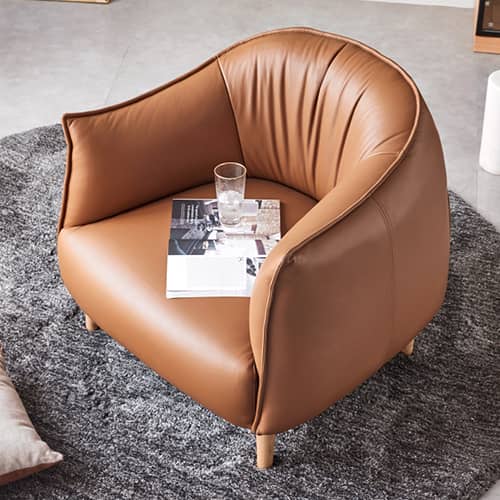 流れるような曲線と高級感のある本革を持つ一人掛けソファ